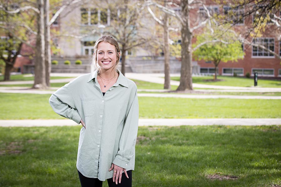 Makenna Johannsen, standing in front of Colden Hall, graduates from Northwest this spring with her bachelor's degree in marketing and communication with an emphasis in public relations. (Photo by Lauren Adams/Northwest Missouri State University)