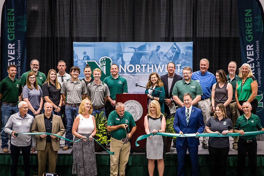 The Northwest community celebrated the opening of the Agricultural Learning Center Friday. Left to right In the first row are Dr. Bob Burrell, president of the Northwest Foundation; Scott Kuhlmeyer, director of capital programs; Mitzi Marchant, vice president of university advancement and executive director of the Northwest Foundation; Dr. Rod Barr, director of the School of Agricultural Sciences; Chris Chinn, director of the Missouri Department of Agriculture; Rep. Allen Andrews; Bailey Hendrickson, Student Senate president; and Northwest President Dr. John Jasinski. They are surrounded in the second row by Northwest agriculture students, faculty and staff as well as representatives of the city of Maryville, Nodaway County, E.L. Crawford Construction, Clark & Enersen, and the Northwest Foundation. (Photos by Todd Weddle/Northwest Missouri State University)