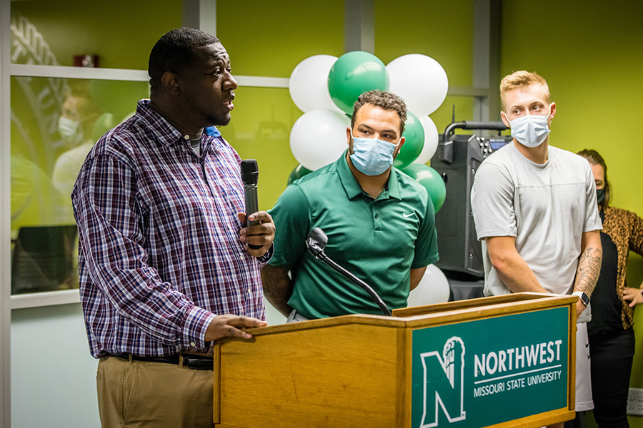 Dr. Justin Mallett, the University’s assistant vice president for diversity and inclusion, is flanked by Northwest student-athletes Elijah Green and Braden Wright as he addresses a crowd gathered Thursday to celebrate the opening of the remodeled Office of Diversity and Inclusion. 