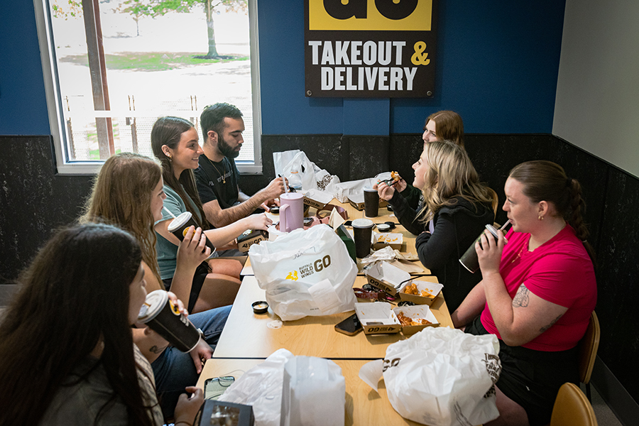 Northwest students enjoy a lunch at the campus's new Buffalo Wild Wings Go, which opened April 29, in The Station.