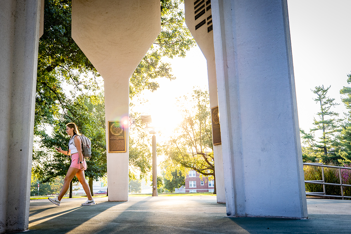 A Northwest students crosses through the Memorial Bell Tower. (Photo by Todd Weddle/Northwest Missouri State University)