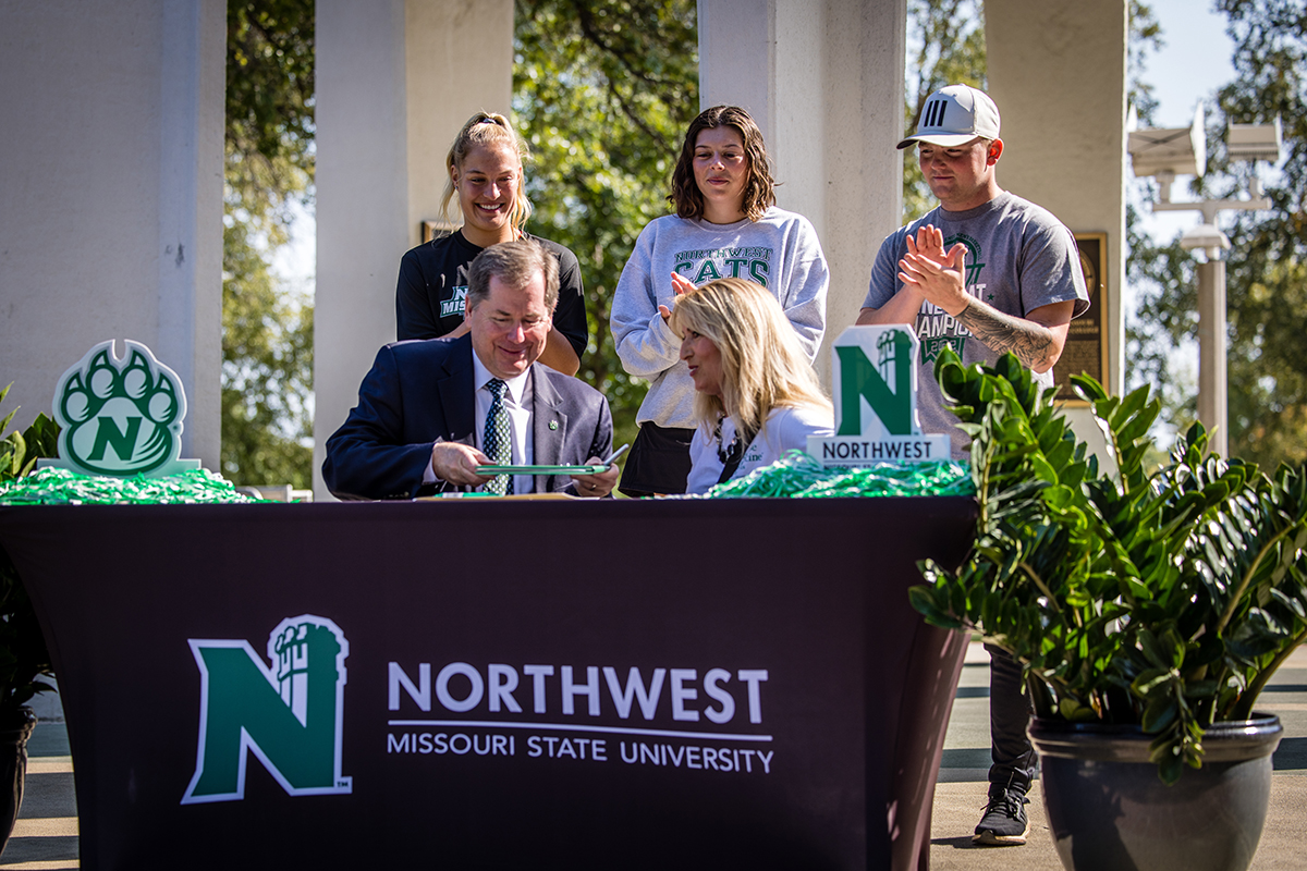 Northwest President Dr. Lance Tatum signed a proclamation Wednesday to designate October as Exercise is Medicine On Campus Month at Northwest. He was joined by Assistant Professor of Health and Physical Education Dr. Tina Pulley and, left to right in back, Applied Health Science Club members Lindsey Kelderman, Lauren Kohl and Tryce Floyd. (Photos by Lilly Cook/Northwest Missouri State University)