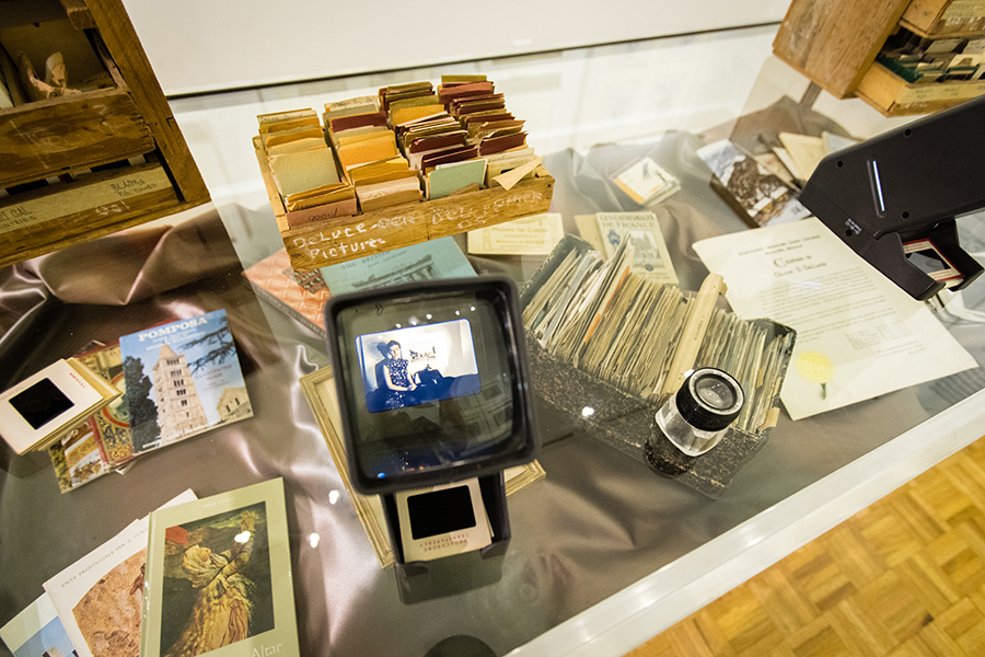 Visitors may interact with the exhibit by viewing Olive DeLuce’s slide collection, which provides insight to her travel experiences through personal snapshots and postcard-like photographs.