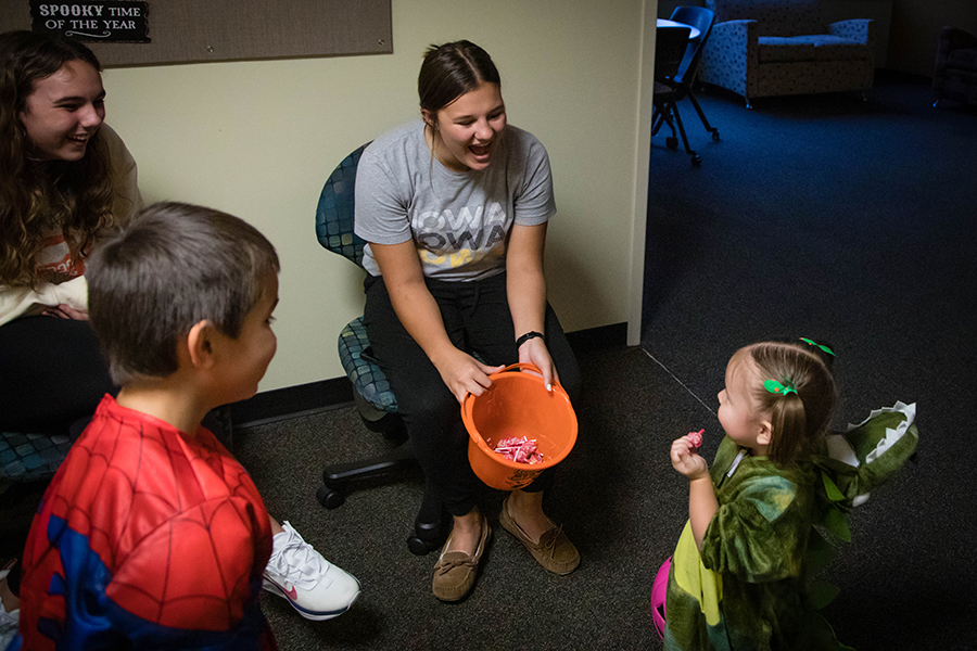 Northwest students greet children inside a residence hall during its annual trick-or-treating event. (Northwest Missouri State University photo)  