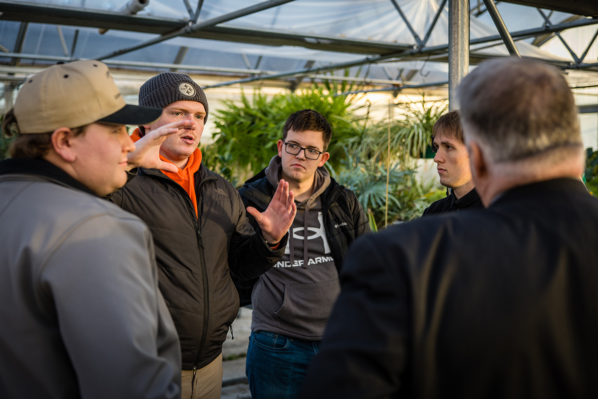 Students in Northwest's Internet of Things course, with faculty and staff on Wednesday, discussed the monitoring system they built to better maintain plant life in University greenhouses. (Photo by Lilly Cook/Northwest Missouri State University)